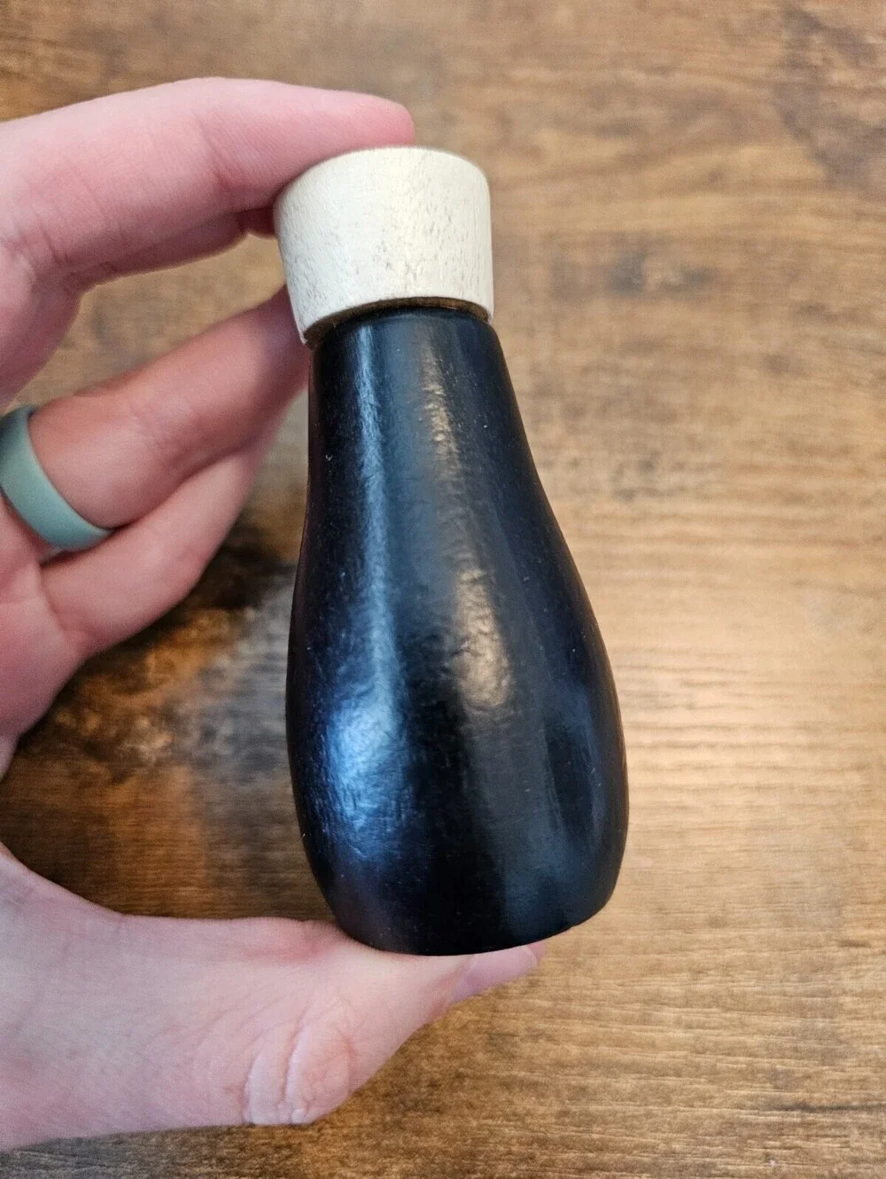 Vintage hand-painted wooden pepper shaker shaped like a penguin